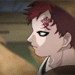 Anime character with red hair and forehead marking in profile view, wearing dark clothing with white trim, against blurred background.