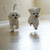 Pixelated dog icon with two poses on a light background, next to a blue with pink text and symbols