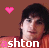 six identical pixelated images showing a person with dark hair against a brown background, each featuring the text 'ashton' and pink heart symbols