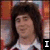 A pixelated image of a person with long dark hair wearing a white shirt, displayed in four showing sequential facial expressions and text overlays