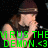 A person wearing a dark beanie and sleeveless shirt sings into a microphone with hand near mouth, green text overlays visible.