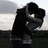 Pixelated image of two figures embracing on a rooftop with red text overlay reading "kiss me and tell me you'll never let me go <3".