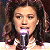 A pixelated contact sheet showing a woman with long brown hair holding a microphone on the left and green text reading "Original Icons .com" on the right against a dark background.