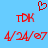 Red pixelated text and symbols on a light blue background, including two 'TDK' labels, two date strings, and a heart shape.