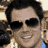 Animated sequence showing multiple views of a person with dark hair and sunglasses, alternating with pixelated text displaying 'Johnny' in green on black backgrounds.