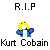 Pixelated graphic with 'R.I.P' text above a yellow-haired figure in blue jacket and white shirt, 'Kurt Cobain' text below on gray background.