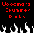 Red pixelated text "Woodmars Drummer Rocks" appears twice on a black background above white and black flame-like shapes.