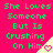 A static image with bright pink background displays green text reading "She Loves Someone But Is Crushing On Him" repeated three times in a , each accompanied by a small heart icon