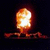 A 2x2 contact sheet of a nuclear explosion animation with text warning about nuclear war, showing an initial fireball and subsequent mushroom cloud over water.