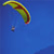 Static 50x50 pixel icon showing a colorful parachute against blue background with small dark object below it.