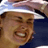 Static 48x48 pixel buddy icon showing a close-up of a person wearing a white and blue striped cap with a dark brim, against a solid dark background.