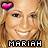 Pixelated image of a smiling person with light brown hair, pink heart-shaped icon above head, and 'MARIAH' text at bottom.