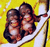 Two monkeys sit on a white surface against a yellow background with brown lines.