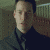 identical pixelated images showing a person in dark clothing against a patterned background, with one blank