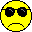 Nine yellow pixelated faces with black sunglasses, arranged in a on gray background; expressions vary from neutral to smiling