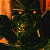 Pixelated character with glowing orange eyes and metallic teeth against dark background, green text 'Original Icons .com' on right side.