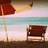 Pixelated beach scene with red umbrella, wooden chair, turquoise water, and pink sky.