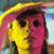 Pixelated image of a stylized face with split yellow and pink coloration, dark hair, and a neutral expression against a blurred background.