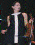 A woman in various poses playing a violin, wearing different outfits against dark or blue backgrounds.