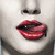 Pixelated close-up of a face with red lips, dark eyes, and light skin tone against a neutral background.
