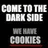 Pixelated image with text "COME TO THE DARK SIDE WE HAVE COOKIES" and a smiling cookie character holding a heart icon.