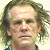 Pixelated mugshot-style image of a person with light brown hair, green text overlays reading 'Nick Nolte', and website attribution at bottom.