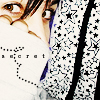 A pixelated close-up of a person's face partially covered by a white fabric with a dotted pattern, wearing a star-patterned garment.