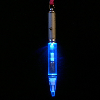 Three vertical pen-shaped objects with glowing sections against a black background, each showing different color states.