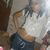 A person in a white crop top and dark shorts poses with one hand on their hip, visible text "3" on the shorts.