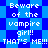 Pixelated blue background with repeating diamond shapes and white text reading "Beware of the vampire girl!! THAT'S ME!!!" in multiple