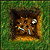 A pixelated brown animal face with a white eye, blue tear-like mark, and yellow detail on green background.
