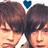 Two people with brown hair stand close together under a blue heart symbol, next to pixelated text reading "i love them!" on black background.