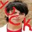 Pixelated static icon of a person with dark hair wearing red clothing and red X-shaped symbols on the background, rendered in low-resolution 256x256 pixels.