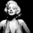 Pixelated grayscale image of a person with short hair wearing a sleeveless top against black background.