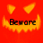 Red background with yellow triangular eyes and jagged mouth; black text 'Beware' centered below the mouth in pixelated font.