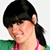 Pixelated close-up of a person with black hair in a ponytail, wearing pink straps and green clothing against a white background.