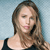 A pixelated image of a person with long brown hair wearing a black sleeveless top against a light blue background.