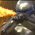 Pixelated static image of a character in dark armor with glowing yellow energy effects on the left side, set against a brown background.