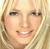 Pixelated close-up of a smiling person with blonde hair and light skin tone, static single-frame image.