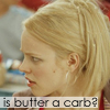 A close-up profile view of a person with blonde hair tied back, wearing a hoop earring and a red garment, with text overlay reading 'is butter a carb?'