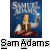 Pixelated image of a person in historical attire holding a torch against a blue background with text above and 'Sam Adams' below.