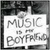 Static image shows a white sign with gray text reading "MUSIC IS MY BOYFRIEND" against dark background, next to blue heart-shaped hands forming a frame.