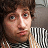 Pixelated close-up of a person with brown hair holding a striped object against a dark background.