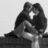 Black-and-white pixelated image of two figures in close embrace with a white cross symbol between them against light background.