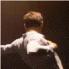 A person in a white shirt with arms outstretched appears from multiple angles against dark backgrounds, showing motion blur and changing lighting conditions.