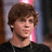 A person with brown hair in a black shirt appears across four showing slight head and eye position changes