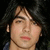 A person with long dark hair and a blue garment appears in three distinct views showing subtle facial expression changes against black backgrounds.
