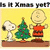 Pixelated image of Snoopy, Charlie Brown, and a Christmas tree on yellow background with brown base.
