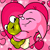 Pixelated image of a pink character with closed eyes embracing a green frog-like creature against a pink heart-shaped background.