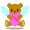 Brown teddy bear with light blue wings holding a pink heart, seated on gray background.